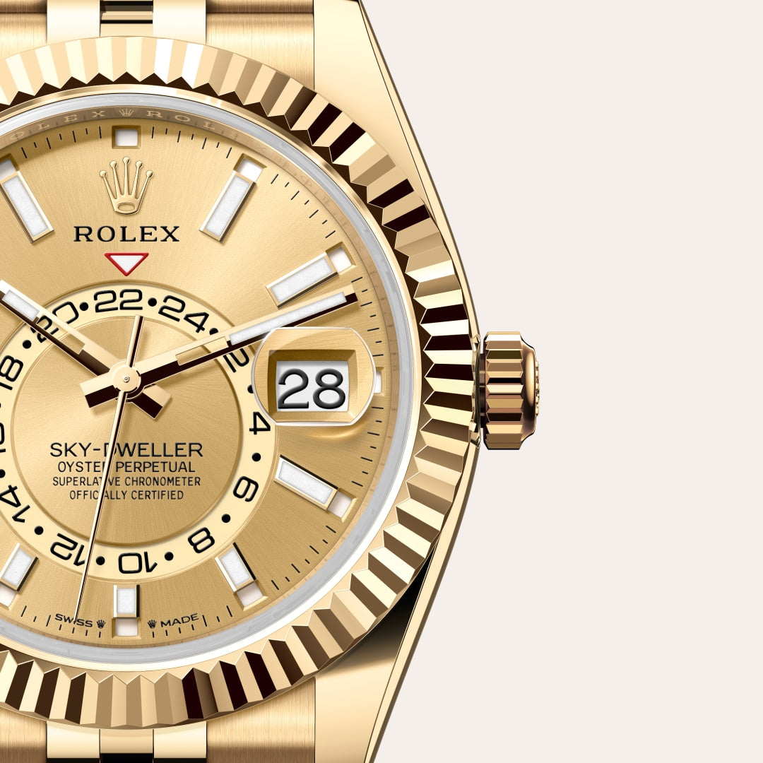 Close-up of a gold Rolex Sky-Dweller watch showing the dial, date window, and the fluted bezel.
