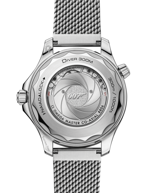 Stainless steel watch with textured mesh band showing caseback featuring 007 logo and "Omega Master Co-Axial" text.