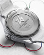 Close-up of a watch case with brand logo on a light background