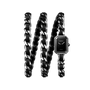The Chanel Première Iconic Chain watch features black leather, a black-lacquered dial, and a long silver chain-link strap coiled in three loops against a white background.