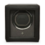 Black leather watch winder with single rotating cradle, Wolf branding, and power button on front face.