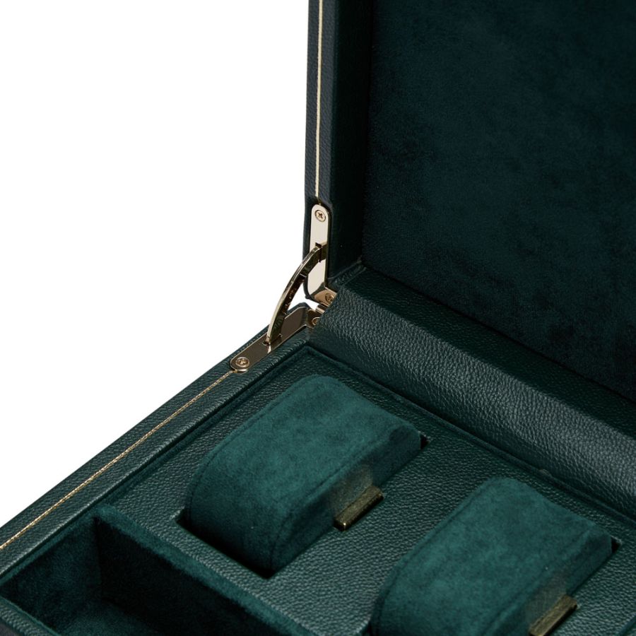 Open teal leather case with metal clasp containing one watch winder and storage compartment with velvet-lined sections.