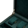 Open teal leather case with metal clasp containing one watch winder and storage compartment with velvet-lined sections.