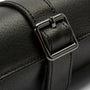 Black leather watch roll with metal buckle closure and stitched compartments for storing multiple watches.