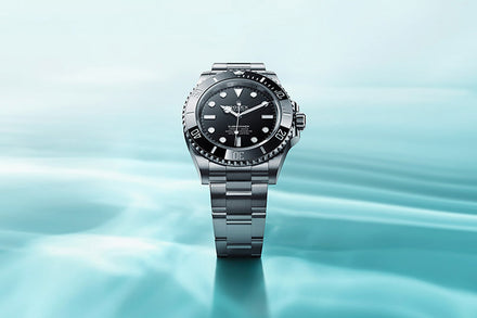 Rolex Submariner over a blue water-like background