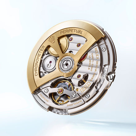 Close-up of a Rolex watch movement featuring gold and silver components with detailed engravings.