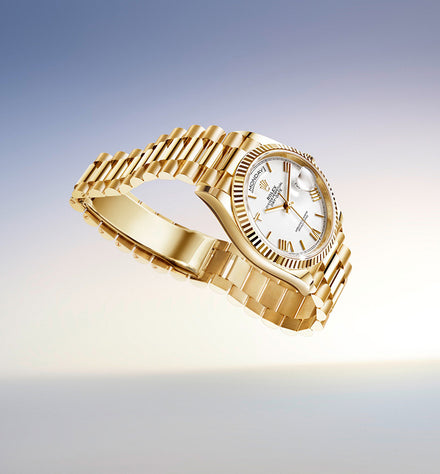 Gold luxury wristwatch with a white dial, floating against a soft gradient background of blue and beige tones.