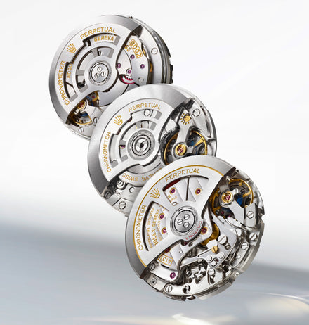 Three intricate Rolex watch movements stacked diagonally, showcasing detailed gears and engraved markings.