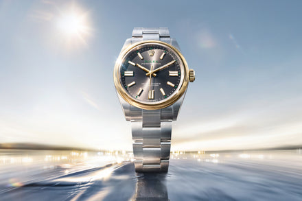 Luxury watch with silver and gold band on a blurred background