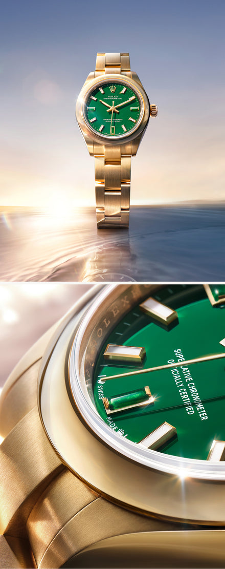 Gold watch with green face against a scenic background