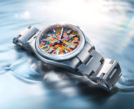 Silver watch with a colorful face on a water background