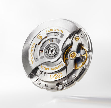 Close-up of a Rolex watch mechanism on a white background