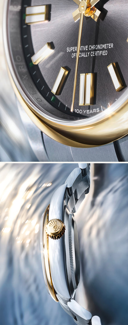 Close-up of a luxury watch with gold and silver accents on a light background