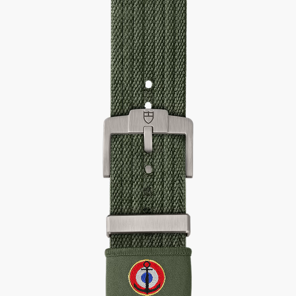 Green watch strap with silver buckle on a white background