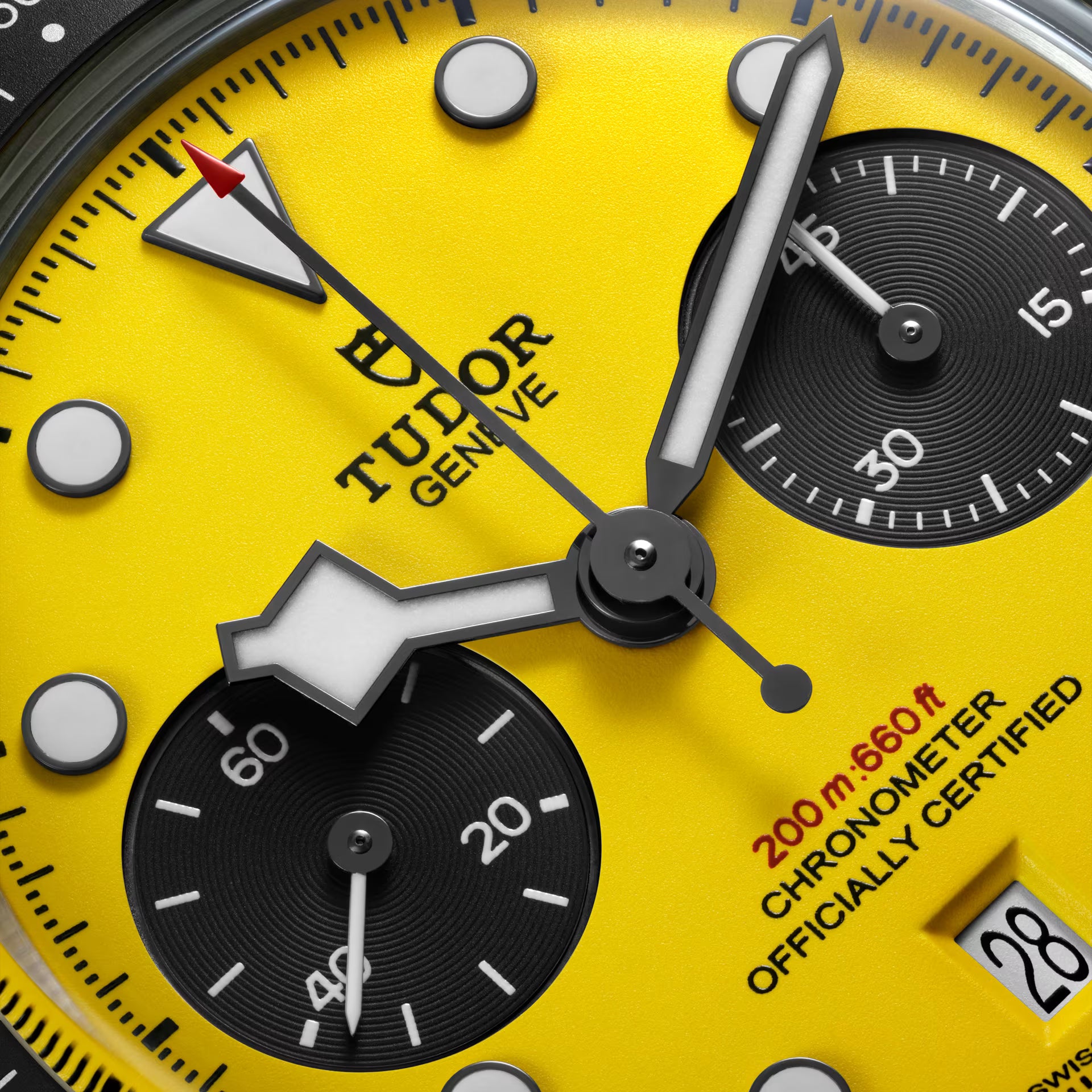 Mens watch with bright yellow dial, black chronograph subdials, white hour markers, and black hands with TUDOR text.