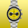 Tudor chronograph watch with yellow dial, black bezel, two black subdials, and steel bracelet on yellow background.
