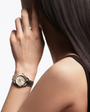 Model wearing the OMEGA Seamaster Aqua Terra 150M 30mm, Moonshine™ gold on steel, Moonshine™ gold Bezel, Silver Dial Watch with a Moonshine™ gold on steel integrated two-tone bracelet.