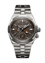 Stainless steel watch with dark brown dial, dual time zone subdial, orange triangle indicator, and metal bracelet.